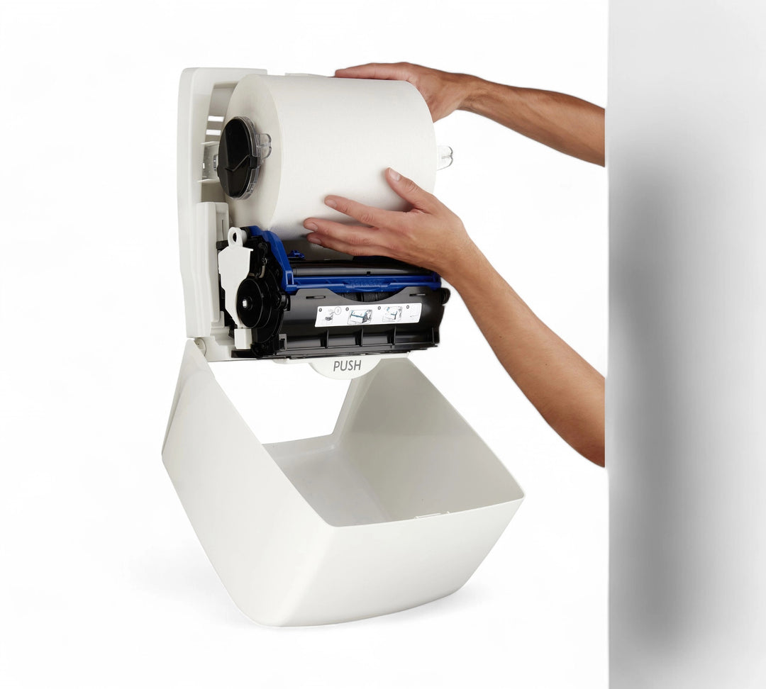 Hands refilling the AQUARIUS Rolled Hand Towel Dispenser (7375), showcasing internal mechanics and roll loading process
