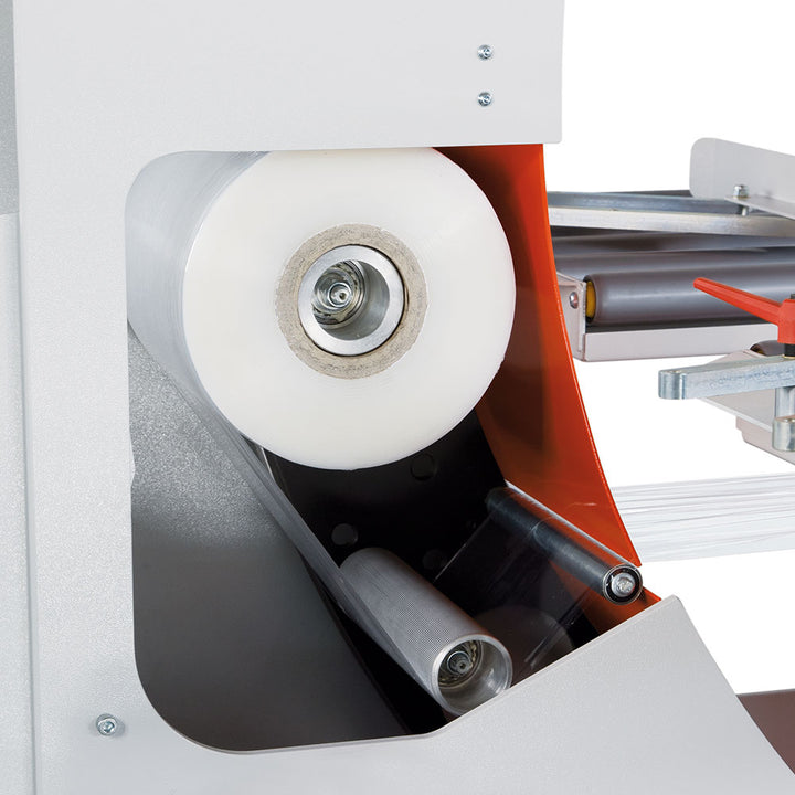 Close-up of stretch film roll inside AT-A automatic horizontal wrapper showing internal roller mechanism