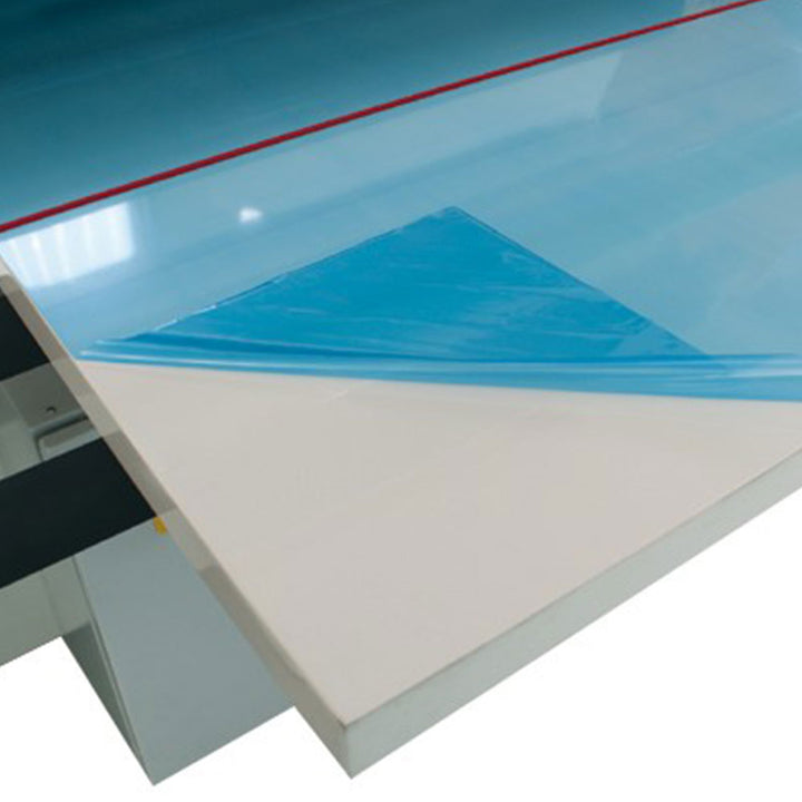 Protective plastic film applied to smooth panel using industrial lamination equipment to prevent scratches and contamination