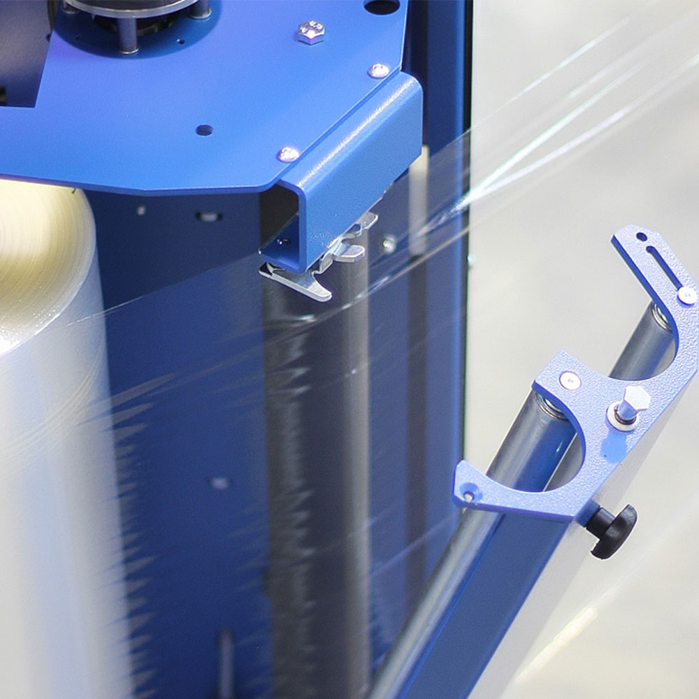 PSE 3500 stretch wrapper carriage with film roll loaded, showing precision-engineered tension rollers for consistent wrap force